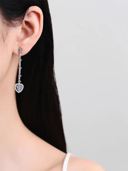 Trendsi 2 carat moissanite heart earrings worn on ear with long silver drop design