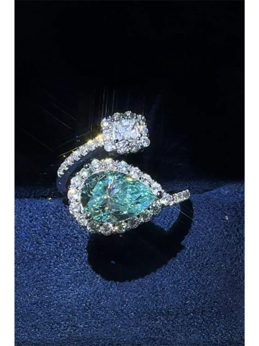 2 carat pear shaped Bypass ring sparkle featuring a pear-shaped blue gemstone and a square clear stone by Trendsi
