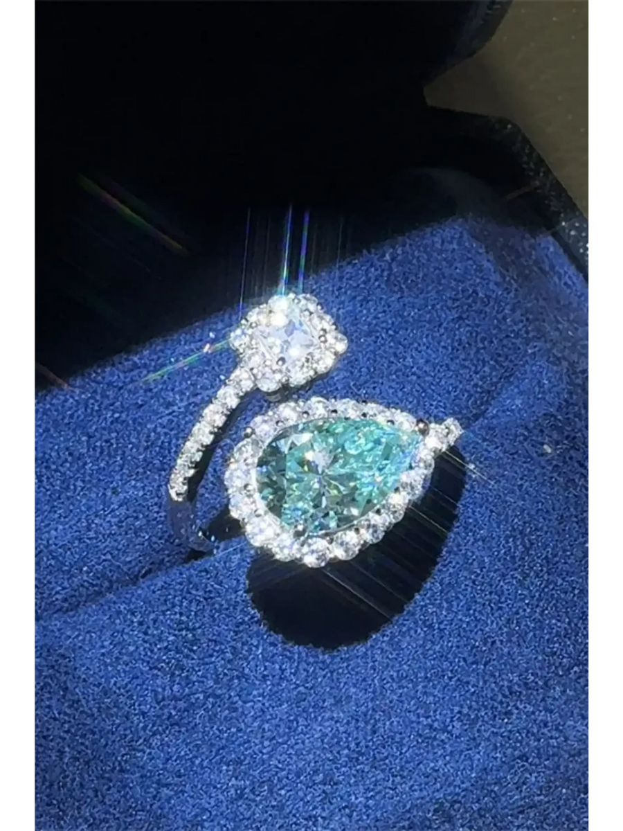 Babe Beachwear 2 carat pear shaped Bypass ring sparkle with a blue gemstone and diamond accents on silver band