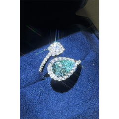 Babe Beachwear 2 carat pear shaped Bypass ring sparkle with a blue gemstone and diamond accents on silver band