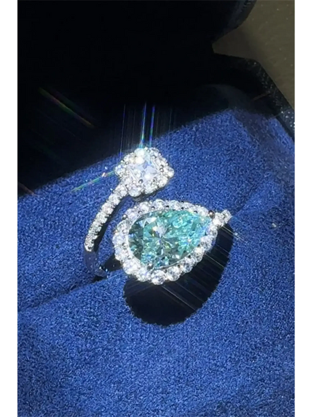 Babe Beachwear 2 carat pear shaped Bypass ring sparkle with a blue gemstone and diamond accents on silver band