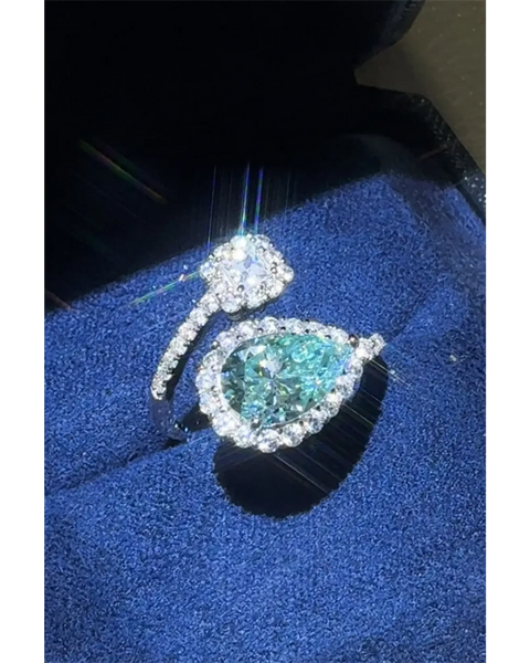 Babe Beachwear 2 carat pear shaped Bypass ring sparkle with a blue gemstone and diamond accents on silver band