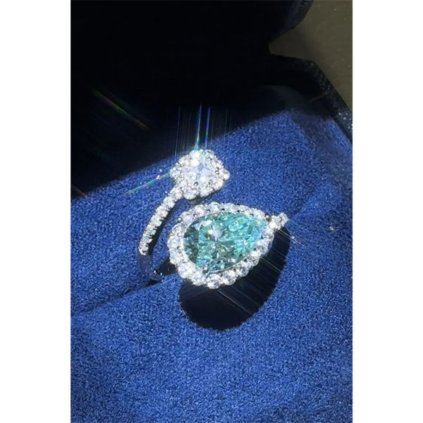 Babe Beachwear 2 carat pear shaped Bypass ring sparkle with a blue gemstone and diamond accents on silver band