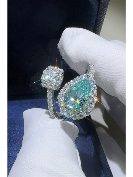 Babe Beachwear  2 carat pear shaped Bypass ring sparkle with a large pear shaped center stone and smaller surrounding diamonds