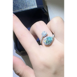 Babe Beachwear 2 carat pear shaped Bypass ring sparkle with clear and blue gemstones on hand