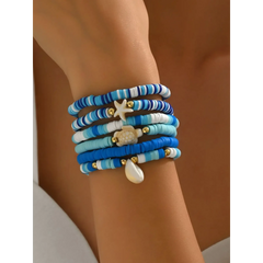 Trendsi blue stackable beach bracelets featuring beads and ocean-themed charms on wrist