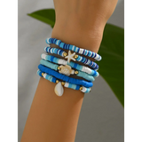 Trendsi blue stackable beach bracelets with seashell and starfish charms on wrist