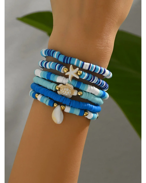 Trendsi blue stackable beach bracelets with seashell and starfish charms on wrist