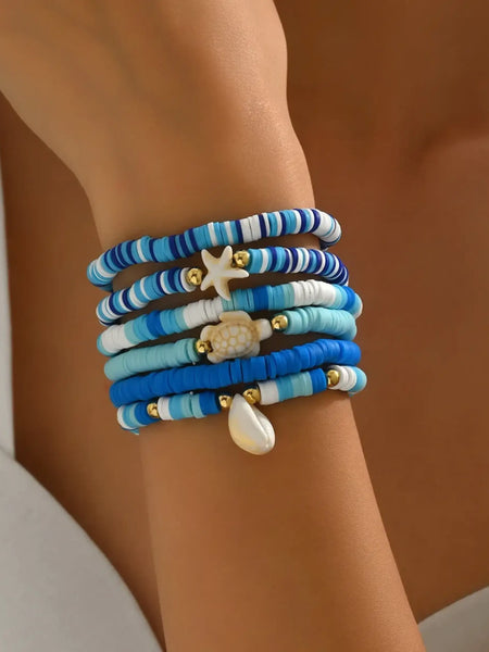 Trendsi blue stackable beach bracelets with starfish and shell charms on wrist
