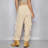 Trendsi beige cargo pants with side pockets worn with tan fringe ankle boots