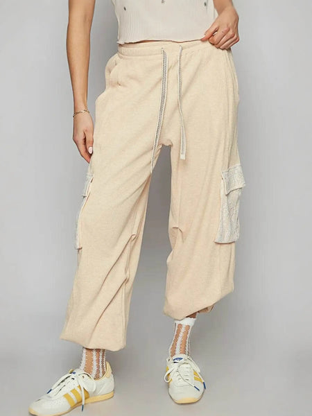 Trendsi beige loose fit Cargo Pants with drawstring waist and side pockets worn with white sneakers