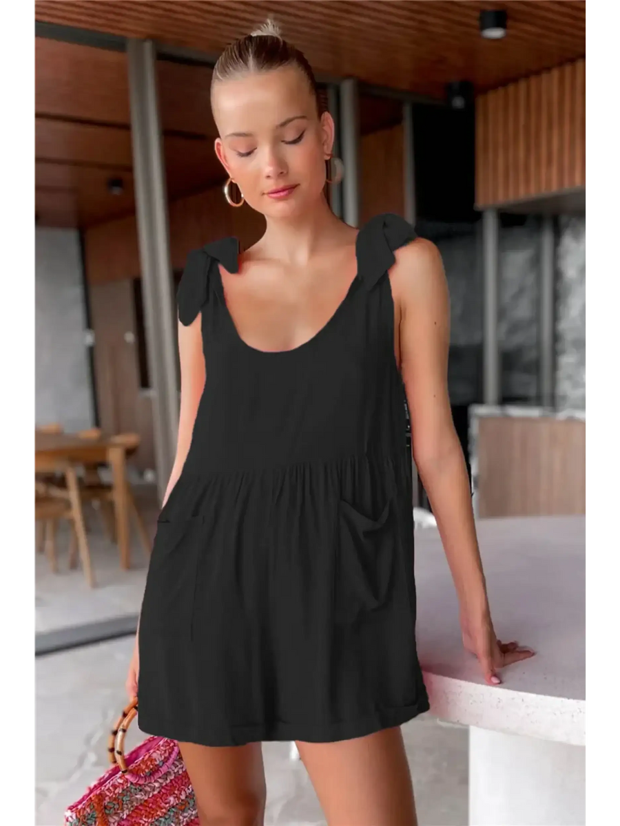 Trendsi casual white vacation romper with shoulder tie straps and pockets worn indoors