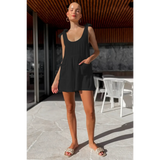 Trendsi black romper worn by a model in an outdoor setting, not a casual white vacation romper