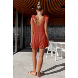 Trendsi casual white vacation romper shown on model from back in rust color with tie shoulder straps