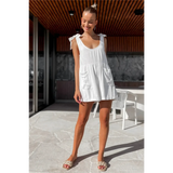 Trendsi casual white vacation romper with shoulder ties worn by woman outdoors with natural light