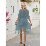 Babe Beachwear chic lightweight beach cover up in light blue knit with fringe hem worn outdoors