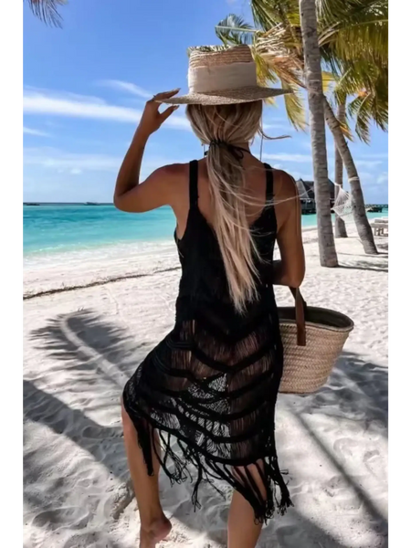 Babe Beachwear black chic tassel beach dress coverup worn on a tropical sandy beach with palm trees