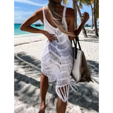 Babe Beachwear white chic tassel beach dress coverup worn on sandy beach with palm trees