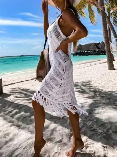 White chic tassel beach dress coverup by Babe Beachwear on a woman at the beach with palm trees