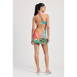 Back view of woman wearing a colorful chic vacation sarong skirt with tropical floral print by Emory Park