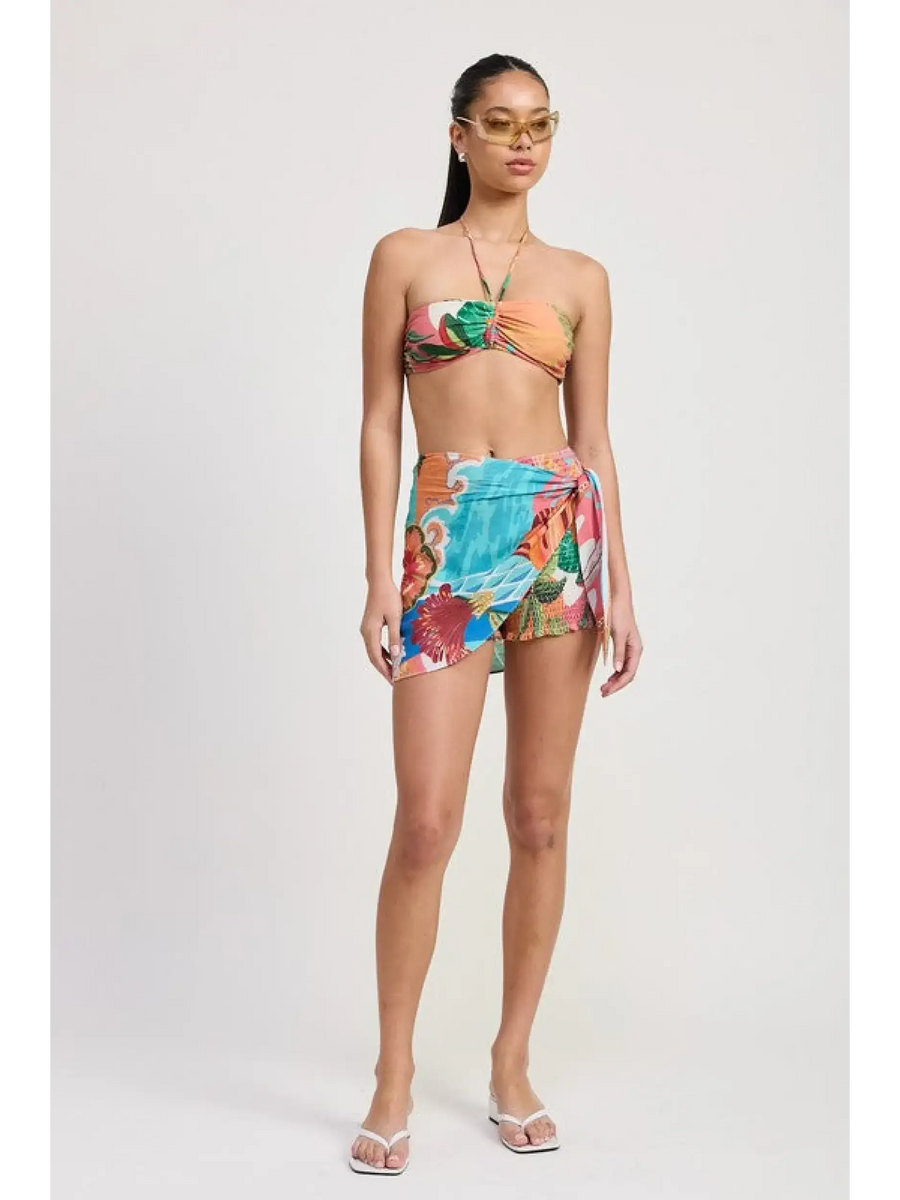 Emory Park model wearing a colorful chic vacation sarong skirt with tropical prints and matching bandeau top