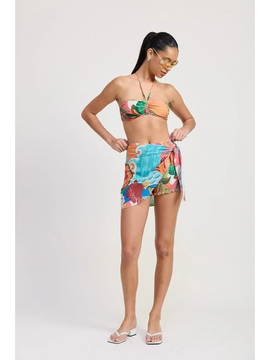 Emory Park chic vacation sarong skirt with colorful tropical print worn by woman with bandeau top