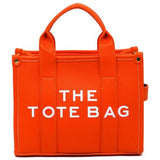 Fashion World Compact Tote Bag Satchel in bright orange with dual handles and bold white text