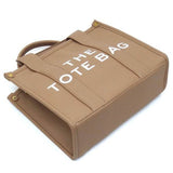 Fashion World Compact Tote Bag Satchel in tan with white printed text and sturdy handles