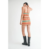 Emory Park crochet halter crop top in multicolor stripes worn with matching skirt and black boots