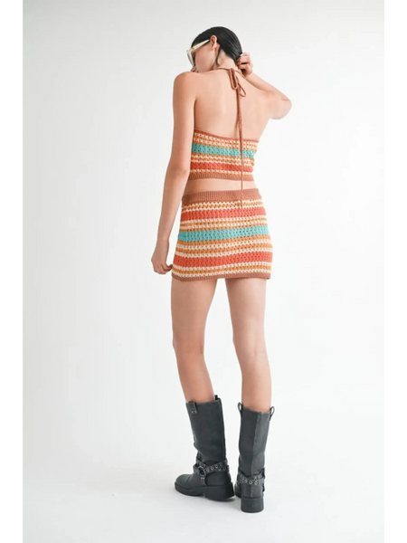 Emory Park crochet halter crop top in multicolor stripes worn with matching skirt and black boots