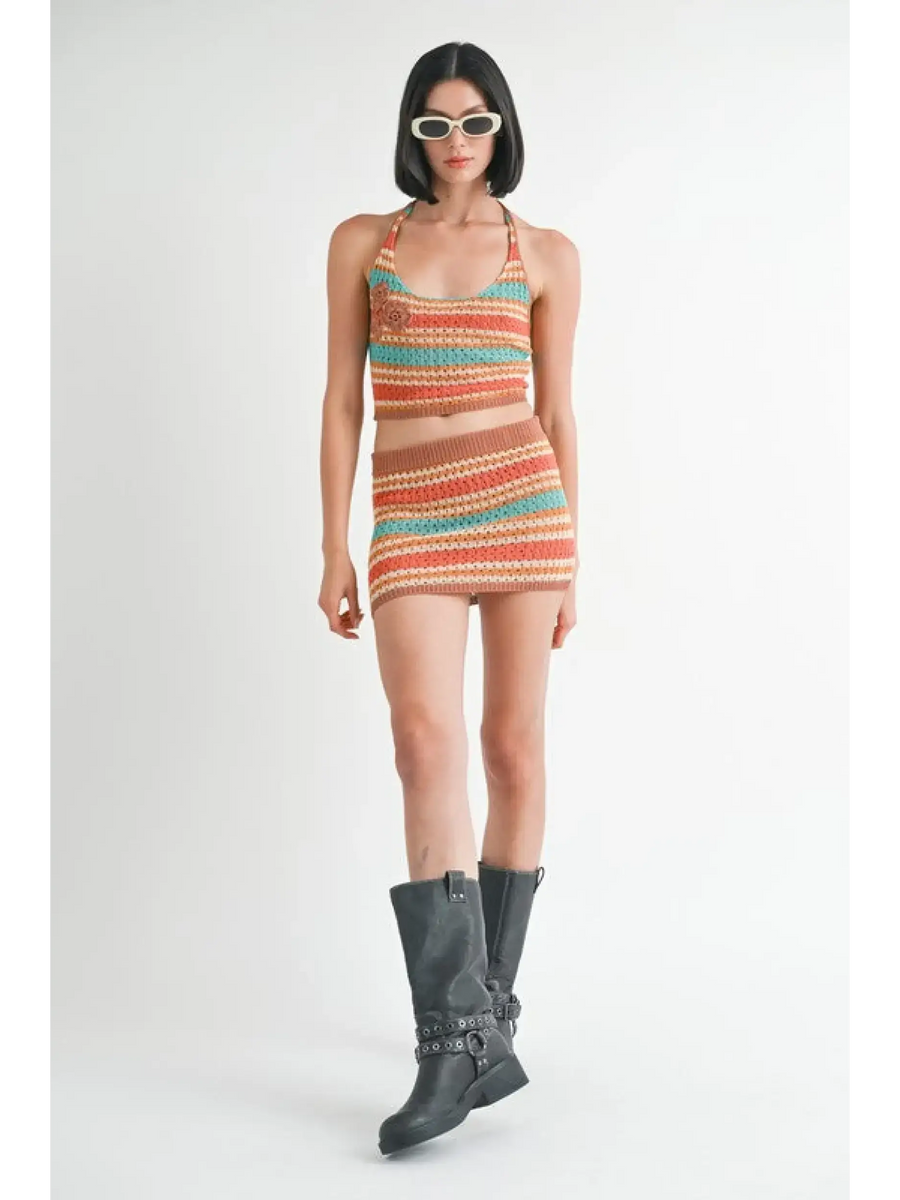 Emory Park crochet halter crop top and matching skirt set worn with black boots and sunglasses