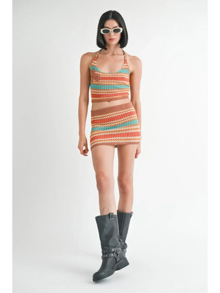 Emory Park crochet halter crop top and matching skirt set worn with black boots and sunglasses