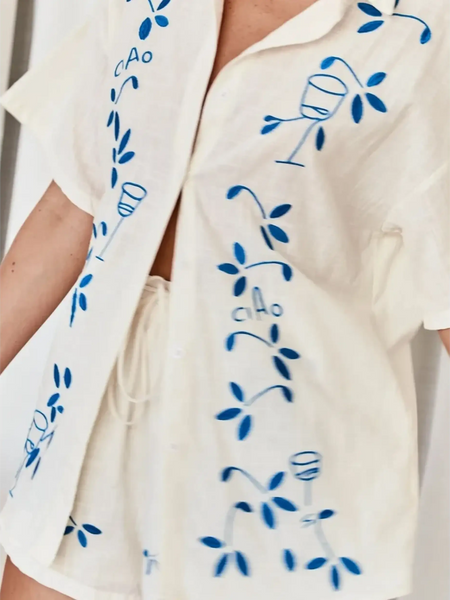 Light beige embroidered shorts set for women with blue floral and wine glass designs from Trendsi