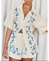 Trendsi embroidered shorts set for women featuring a cream button-up shirt and matching shorts with blue floral embroidery