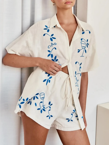 Trendsi embroidered shorts set for women in white with blue floral and wine glass designs