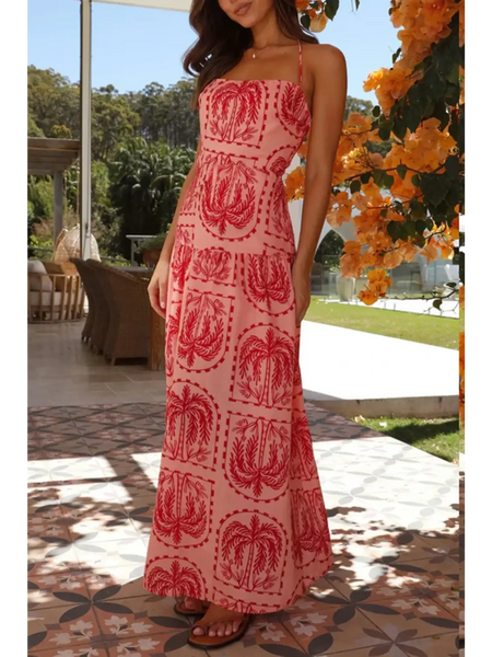 Side View of empire waist maxi dress in pink with red palm tree print and halter neck style