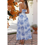 Back View of the  empire waist maxi dress with blue palm tree print and halter neck tie back