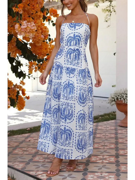 Lovely woman wearing i blue and white printed empire waist maxi dress with spaghetti straps and flowy skirt