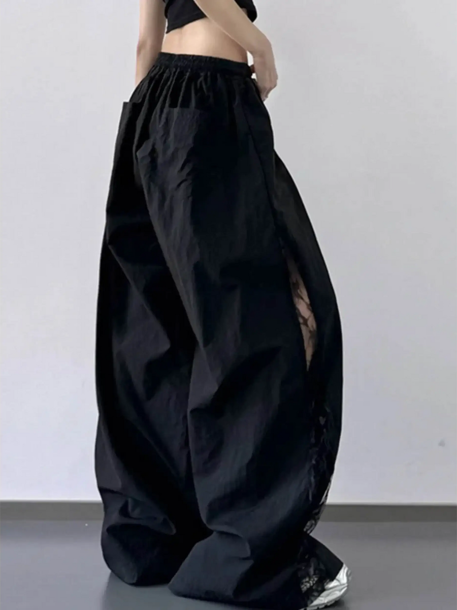 Black extra wide leg flowing beach pants from Babe Beachwaer with elastic waistband and side lace detail