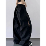 Black extra wide leg flowing beach pants from Babe Beachwaer with elastic waistband and side lace detail
