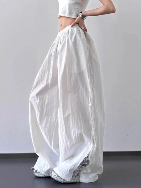 Babe Beachwear extra wide leg flowing beach pants in white worn with a cropped top