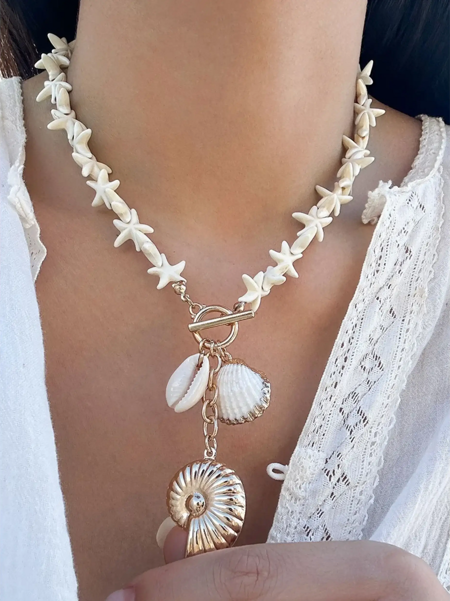 Fashionable Shell Resort Necklace by Trendsi featuring white star-shaped beads and hanging shell charms