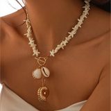 Fashionable Shell Resort Necklace by Trendsi featuring starfish and gold shell charms on model's neck
