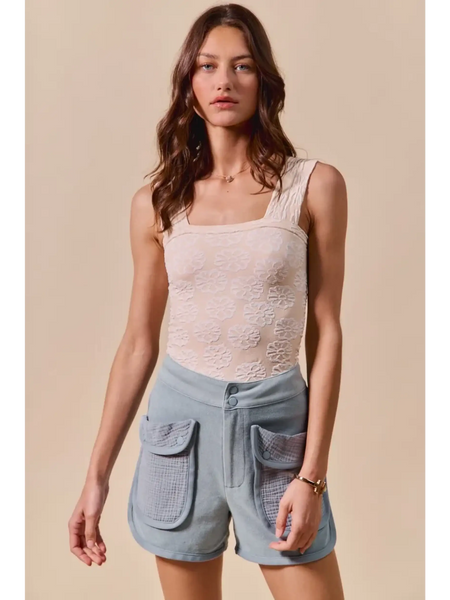 Trendsi High Rise Cargo Shorts in light blue with large front pockets worn by a female model