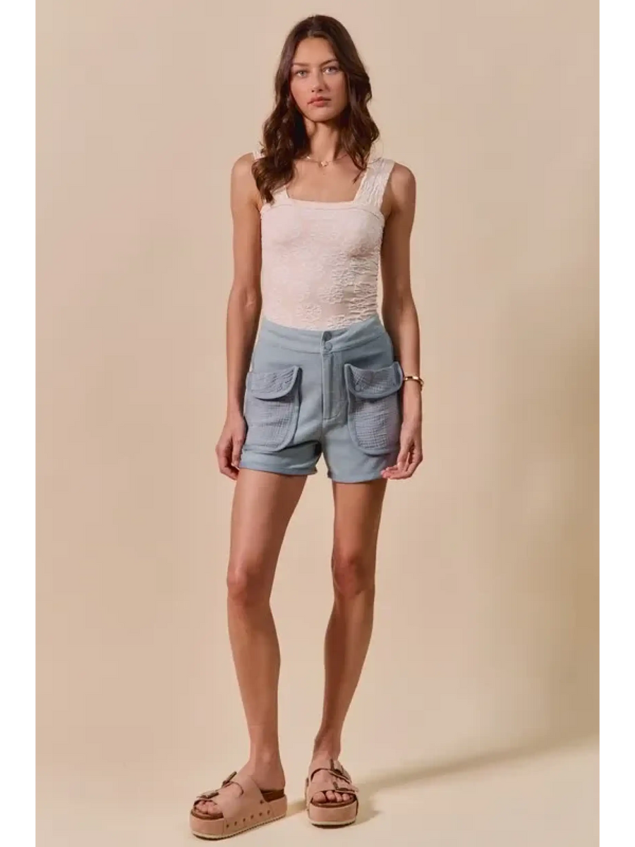 Trendsi High Rise Cargo Shorts in light blue denim with front flap pockets worn with a white tank top