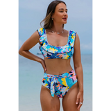 Trendsi high waist bikini set with support top in colorful floral pattern on woman at beach