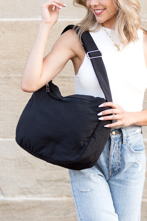 Babe Beachwaer Lula Everywhere Large Nylon Messenger Bag in black worn by woman with white top and jeans