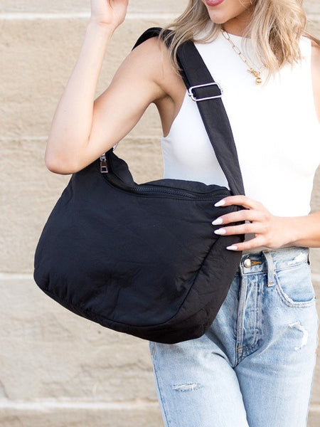 Babe Beachwaer Lula Everywhere Large Nylon Messenger Bag in black worn by woman with white top and jeans