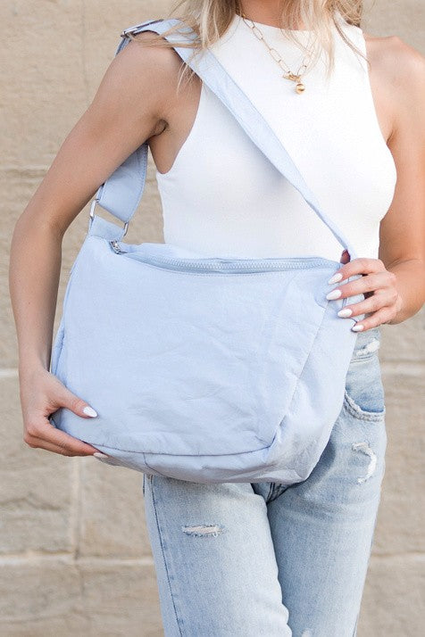 Babe Beachwear Large Nylon Messenger Bag in light blue worn crossbody with adjustable strap