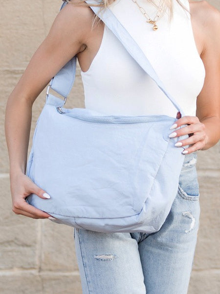 Babe Beachwear Large Nylon Messenger Bag in light blue worn crossbody with adjustable strap